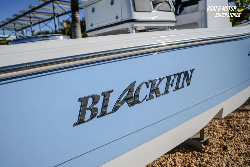  Yacht Photos Pics 2025 Blackfin 242 HB boat side view with logo, displayed at a dealership.