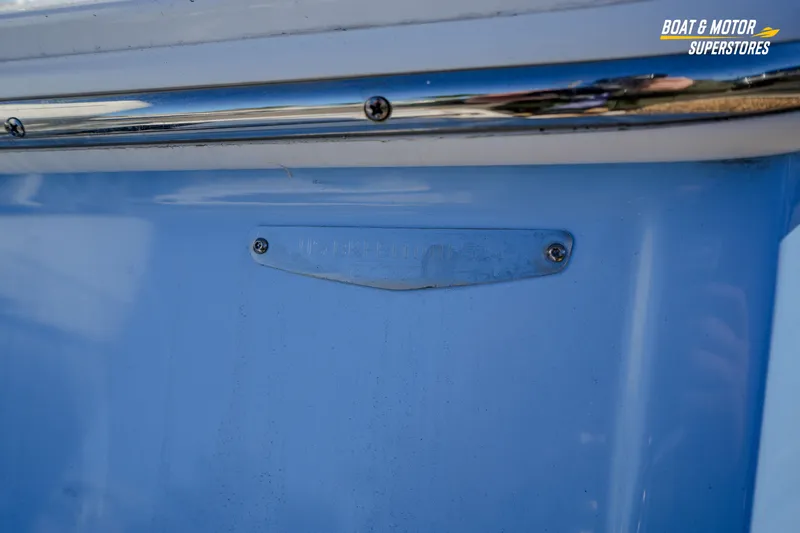  Yacht Photos Pics 2025 Blackfin 242 HB boat detail with blue hull and metal plate.