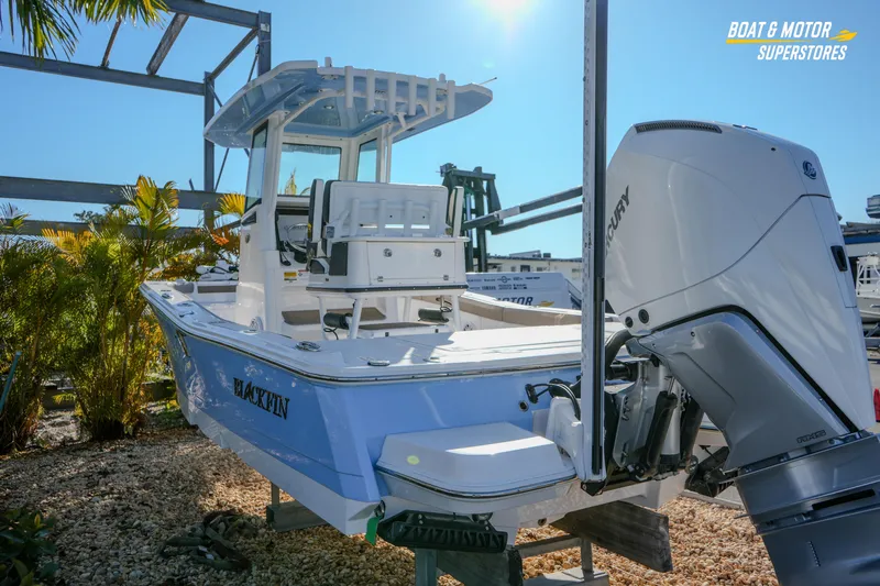  Yacht Photos Pics 2025 Blackfin 242 HB boat with Mercury engine, displayed outdoors at a dealership.