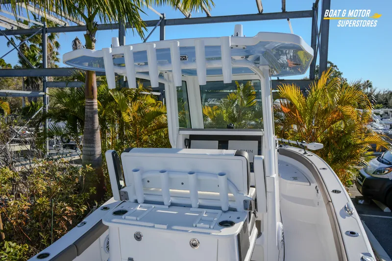 Yacht Photos Pics 2025 Blackfin 242 HB boat with sleek design, surrounded by tropical plants.