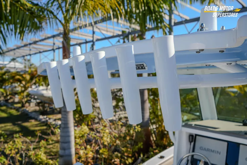  Yacht Photos Pics 2025 Blackfin 242 HB boat with rod holders, palm trees in background.