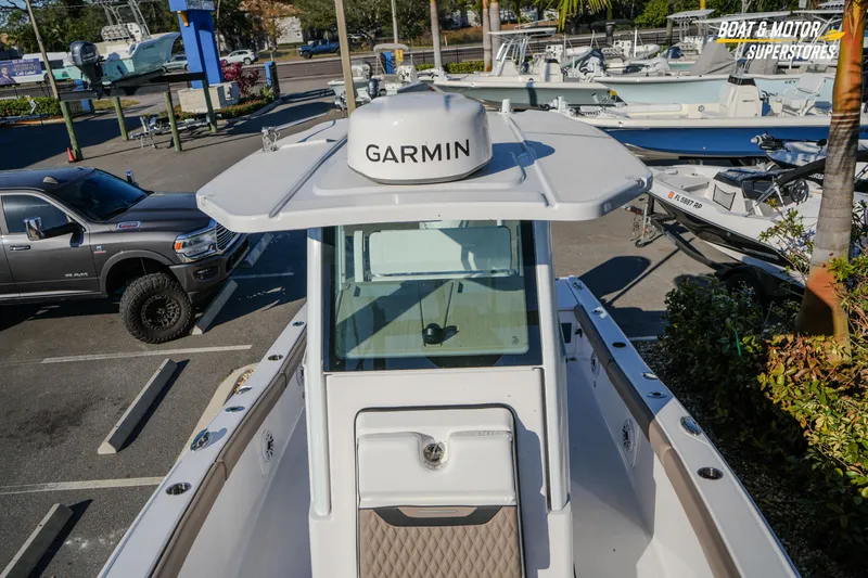  Yacht Photos Pics 2025 Blackfin 242 HB boat with Garmin equipment, parked at a dealership.