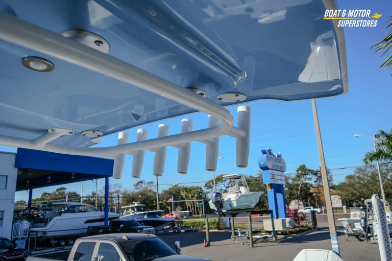  Yacht Photos Pics 2025 Blackfin 242 HB boat detail at dealership, showcasing rod holders and sleek design.