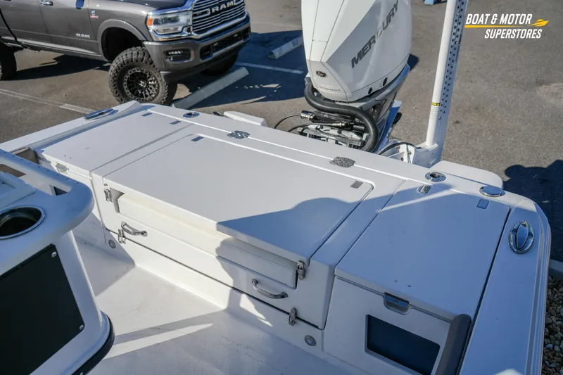  Yacht Photos Pics 2025 Blackfin 242 HB boat with Mercury engine, parked near a RAM truck.