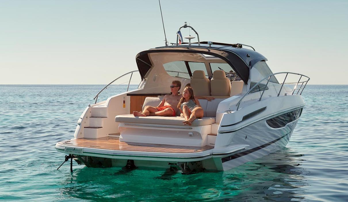 2025 Focus Power 36 yacht on clear water, couple relaxing on deck.
