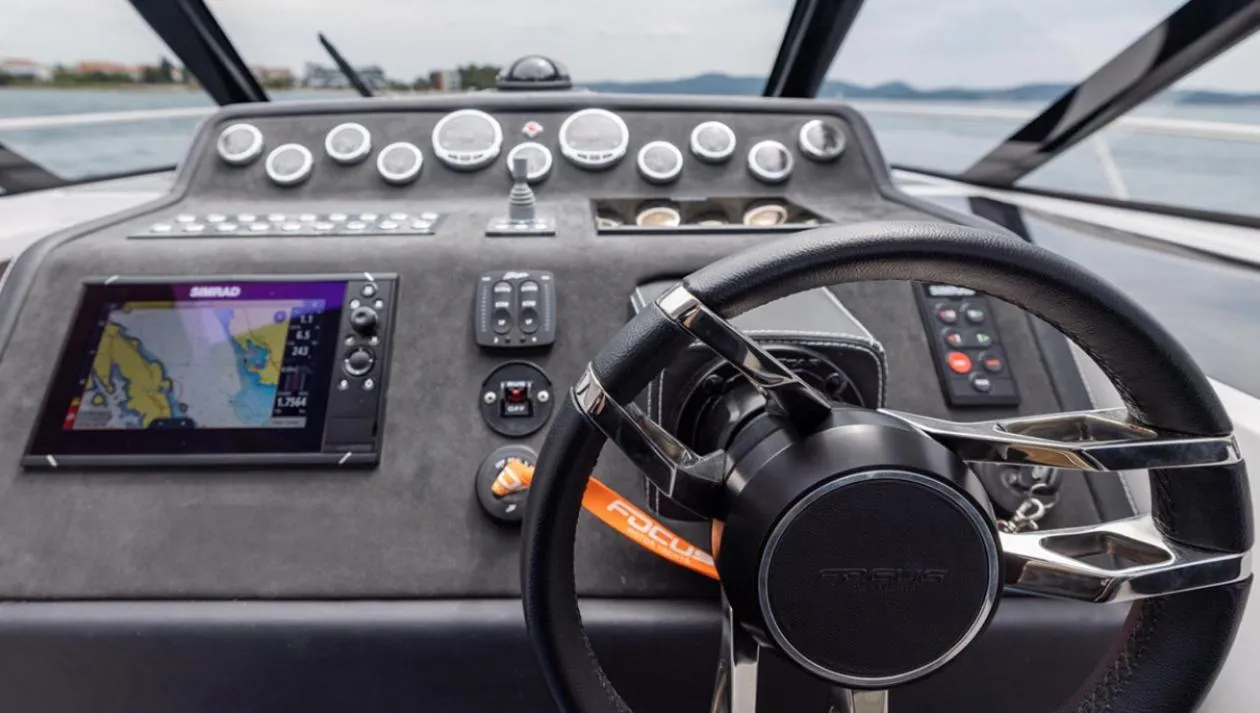 Steering console of 2025 Focus Power 36 boat with navigation display and controls.