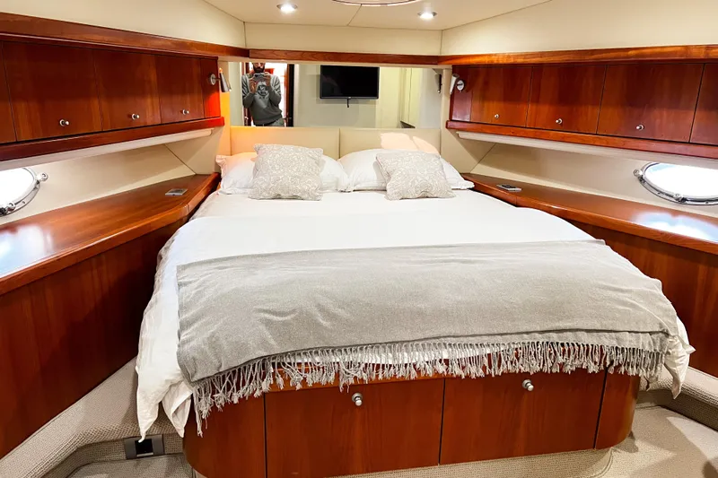  Yacht Photos Pics Luxurious bedroom interior of 2007 Sunseeker Manhattan 66 yacht with elegant wood finish.