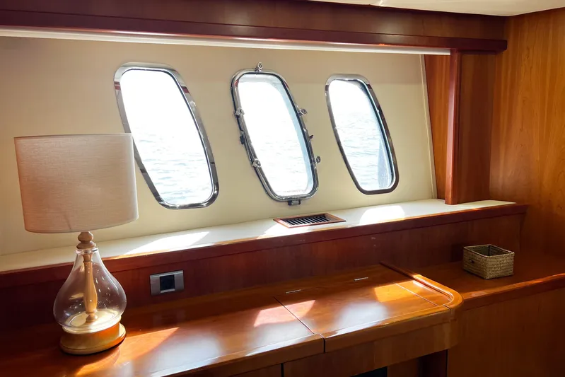  Yacht Photos Pics Interior of 2007 Sunseeker Manhattan 66 yacht with porthole windows and elegant wooden furnishings.