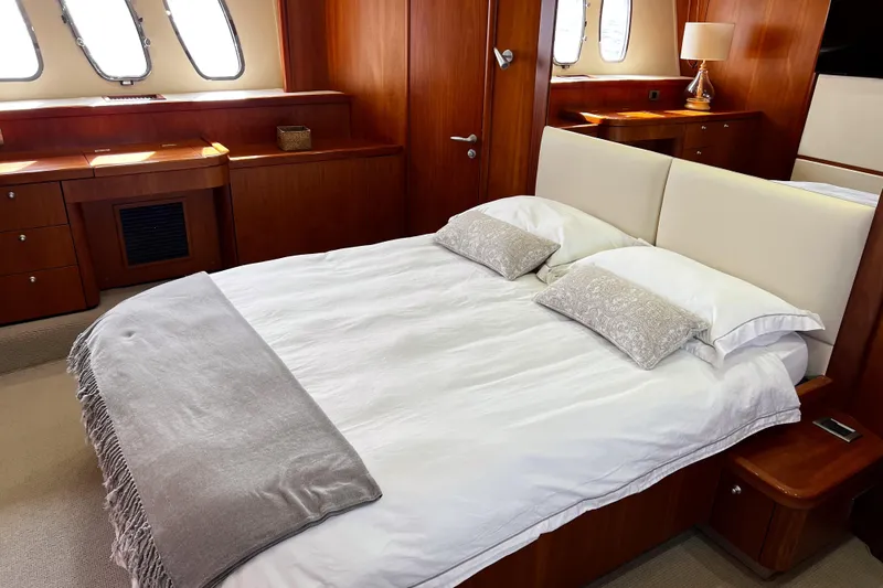  Yacht Photos Pics Luxurious bedroom interior on 2007 Sunseeker Manhattan 66 yacht with elegant wood finish.