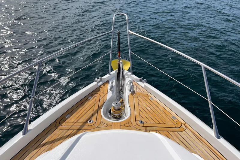  Yacht Photos Pics Bow view of 2007 Sunseeker Manhattan 66 yacht with teak deck on open water.