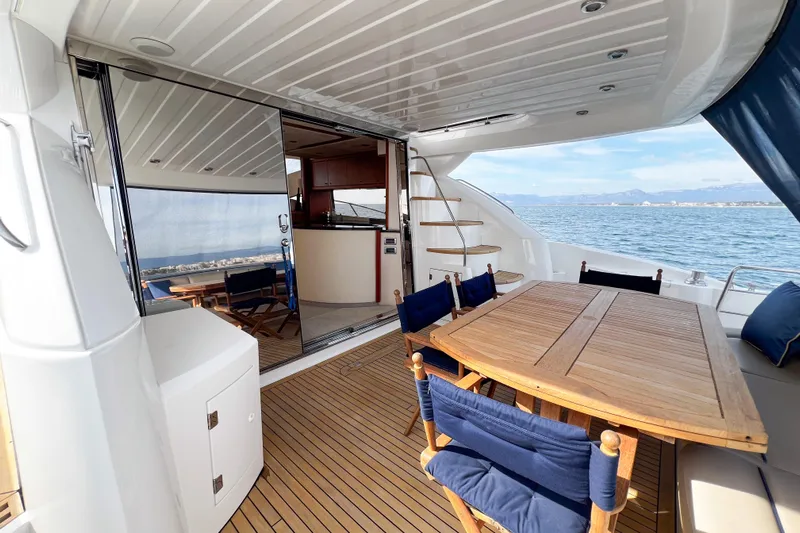  Yacht Photos Pics Luxurious 2007 Sunseeker Manhattan 66 yacht with elegant outdoor dining area and ocean view.