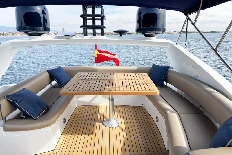  Yacht Photos Pics Luxurious Sunseeker Manhattan 66 yacht deck with seating, table, and ocean view, 2007 model.