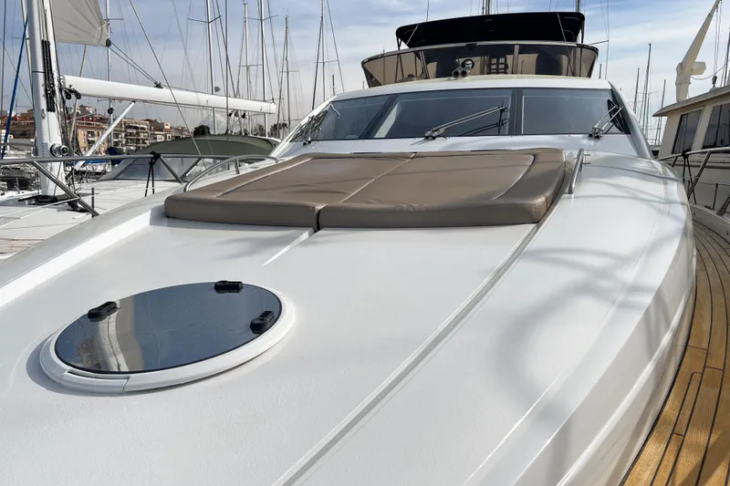  Yacht Photos Pics 2007 Sunseeker Manhattan 66 yacht with sleek deck and sunbathing area in marina.