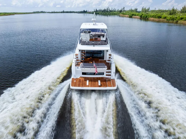  Yacht Photos Pics Prestige 560 Flybridge yacht cruising on a serene waterway, 2017 model.