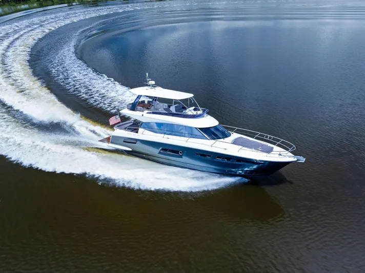  Yacht Photos Pics 2017 Prestige 560 Flybridge yacht cruising on calm waters.