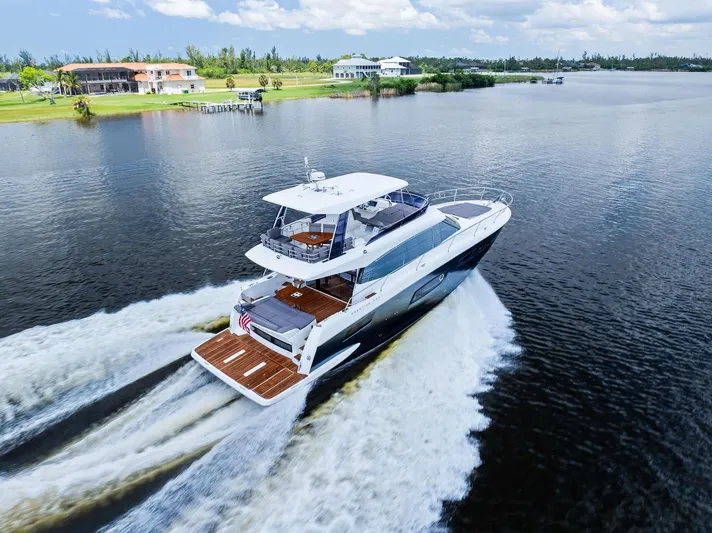  Yacht Photos Pics 2017 Prestige 560 Flybridge yacht cruising on a scenic waterway.