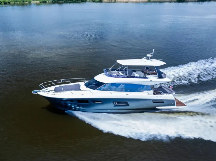  Yacht Photos Pics 2017 Prestige 560 Flybridge yacht cruising on a calm river.