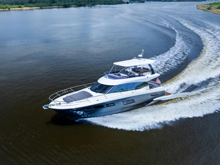  Yacht Photos Pics 2017 Prestige 560 Flybridge yacht cruising on a calm river.