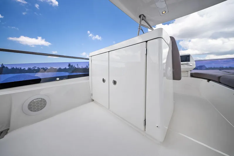  Yacht Photos Pics Prestige 560 Flybridge 2017 yacht deck with storage cabinet under clear blue sky.