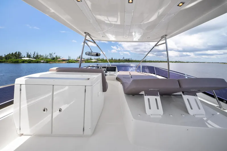  Yacht Photos Pics Luxurious 2017 Prestige 560 Flybridge yacht with spacious deck and seating, cruising on calm waters.