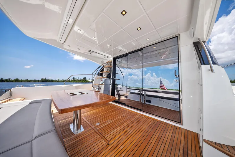  Yacht Photos Pics Luxurious 2017 Prestige 560 Flybridge yacht with sleek deck and elegant seating area.