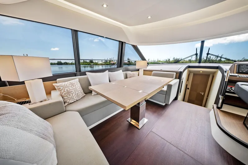  Yacht Photos Pics Luxurious interior of 2017 Prestige 560 Flybridge yacht with elegant seating and panoramic windows.