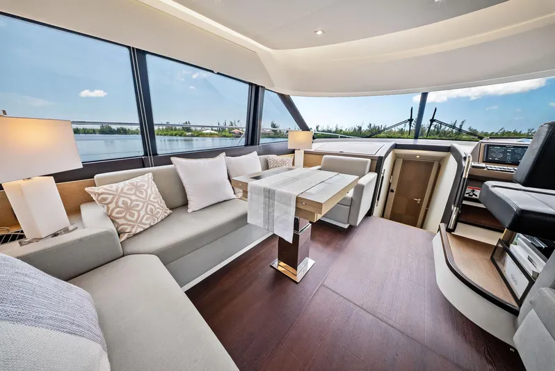  Yacht Photos Pics Luxurious interior of 2017 Prestige 560 Flybridge yacht with elegant seating and panoramic windows.