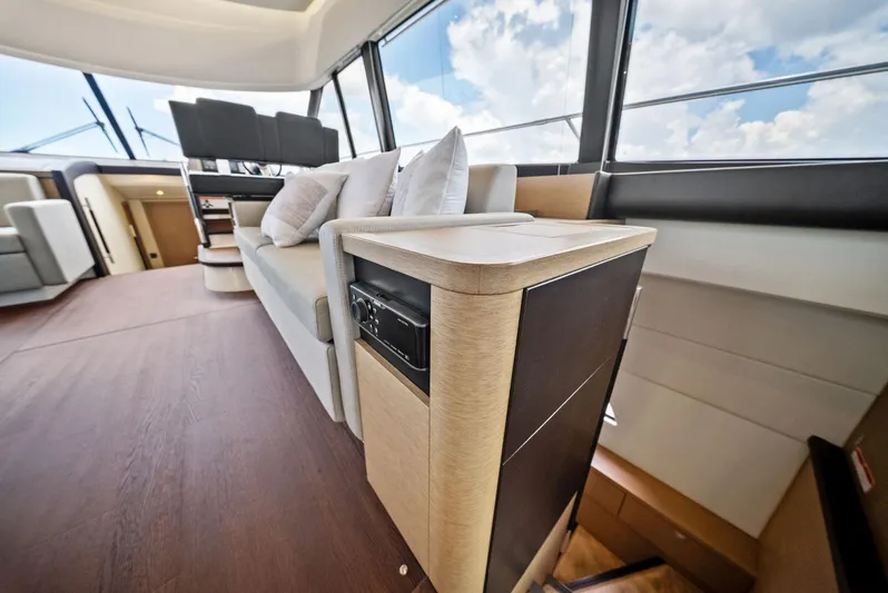  Yacht Photos Pics Luxurious interior of 2017 Prestige 560 Flybridge yacht with modern seating and panoramic windows.