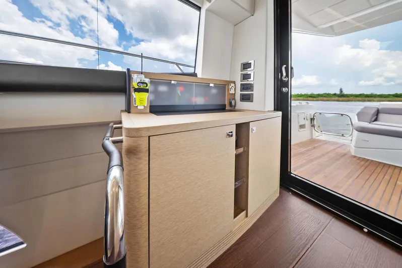  Yacht Photos Pics Interior of 2017 Prestige 560 Flybridge yacht, featuring modern cabinetry and outdoor seating area.