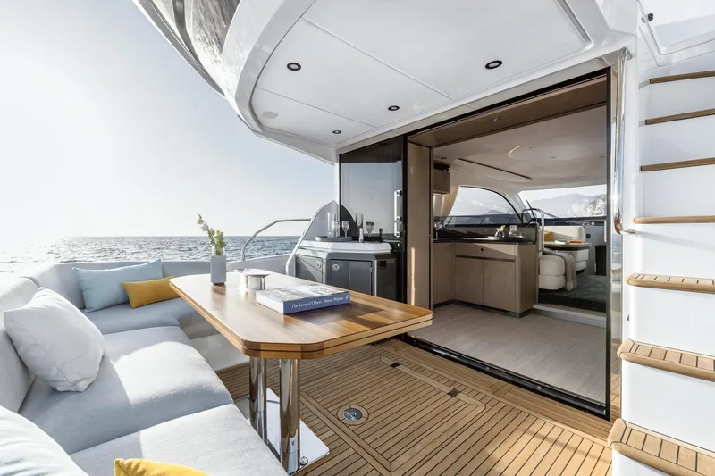  Yacht Photos Pics Luxurious 2024 Azimut Fly 53 yacht interior with ocean view, featuring elegant seating and dining area.