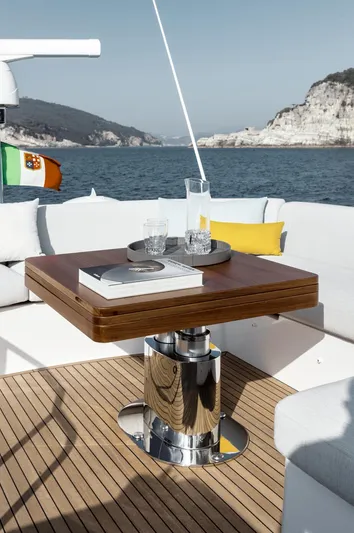  Yacht Photos Pics 2024 Azimut Fly 53 yacht deck with elegant wooden table and scenic ocean view.