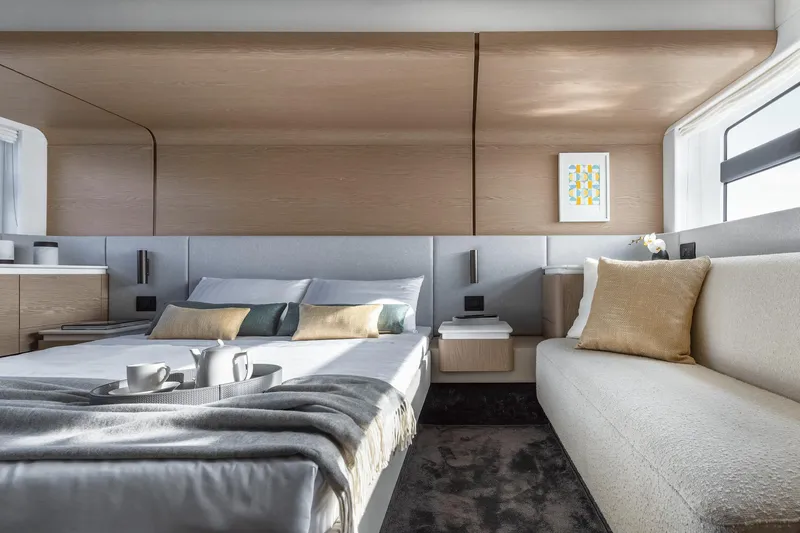  Yacht Photos Pics Luxurious bedroom interior of 2024 Azimut Fly 53 yacht with modern decor and cozy seating.