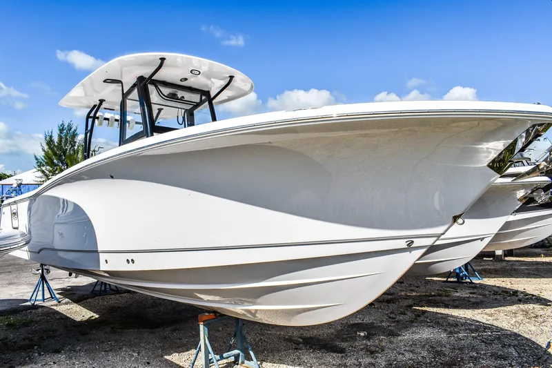  Yacht Photos Pics 2026 Sea Hunt Ultra 305 Coffin Box boat displayed on stands under a clear blue sky.