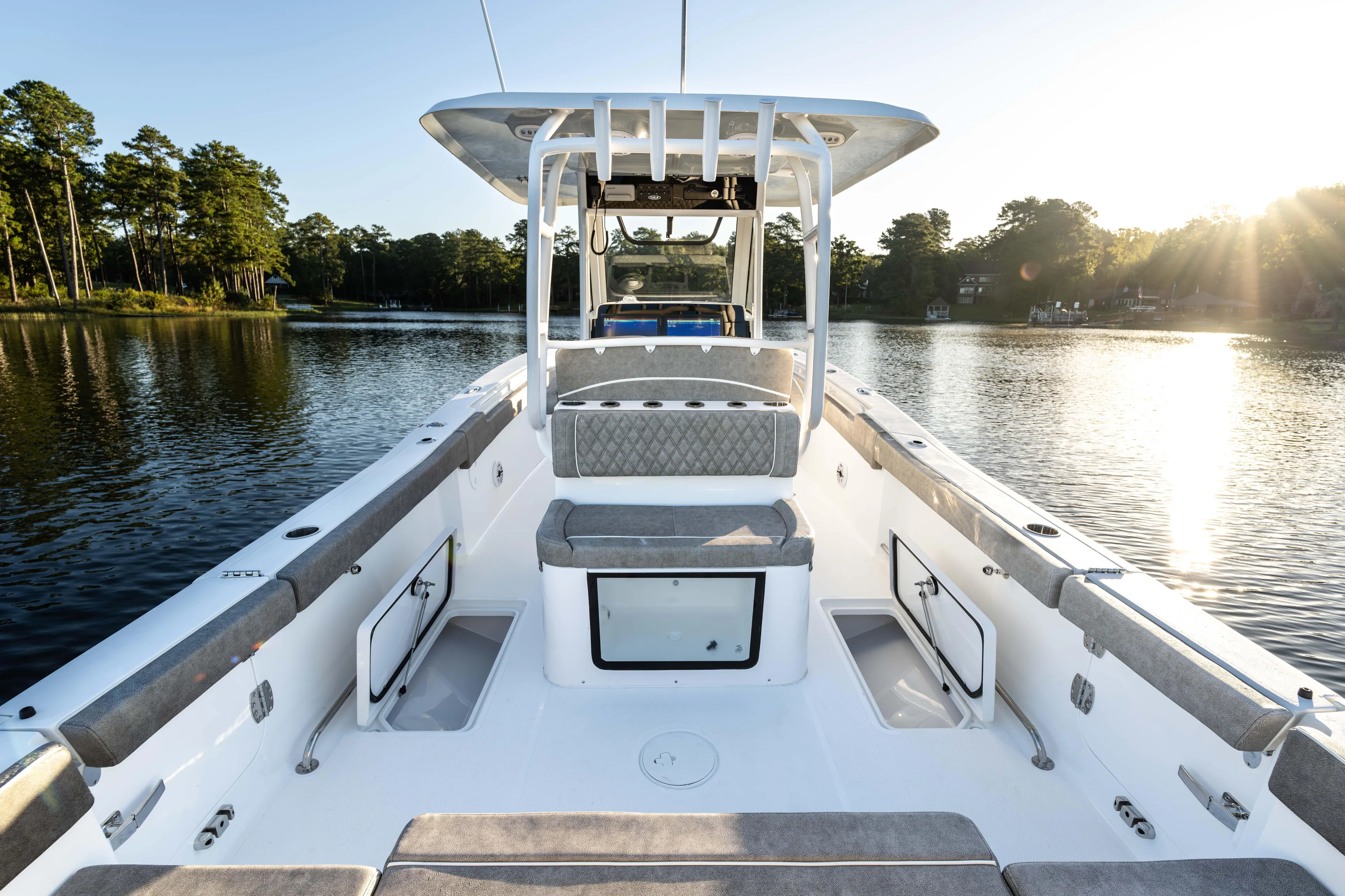  Yacht Photos Pics 2026 Sea Hunt Ultra 305 Coffin Box boat on serene lake at sunset.