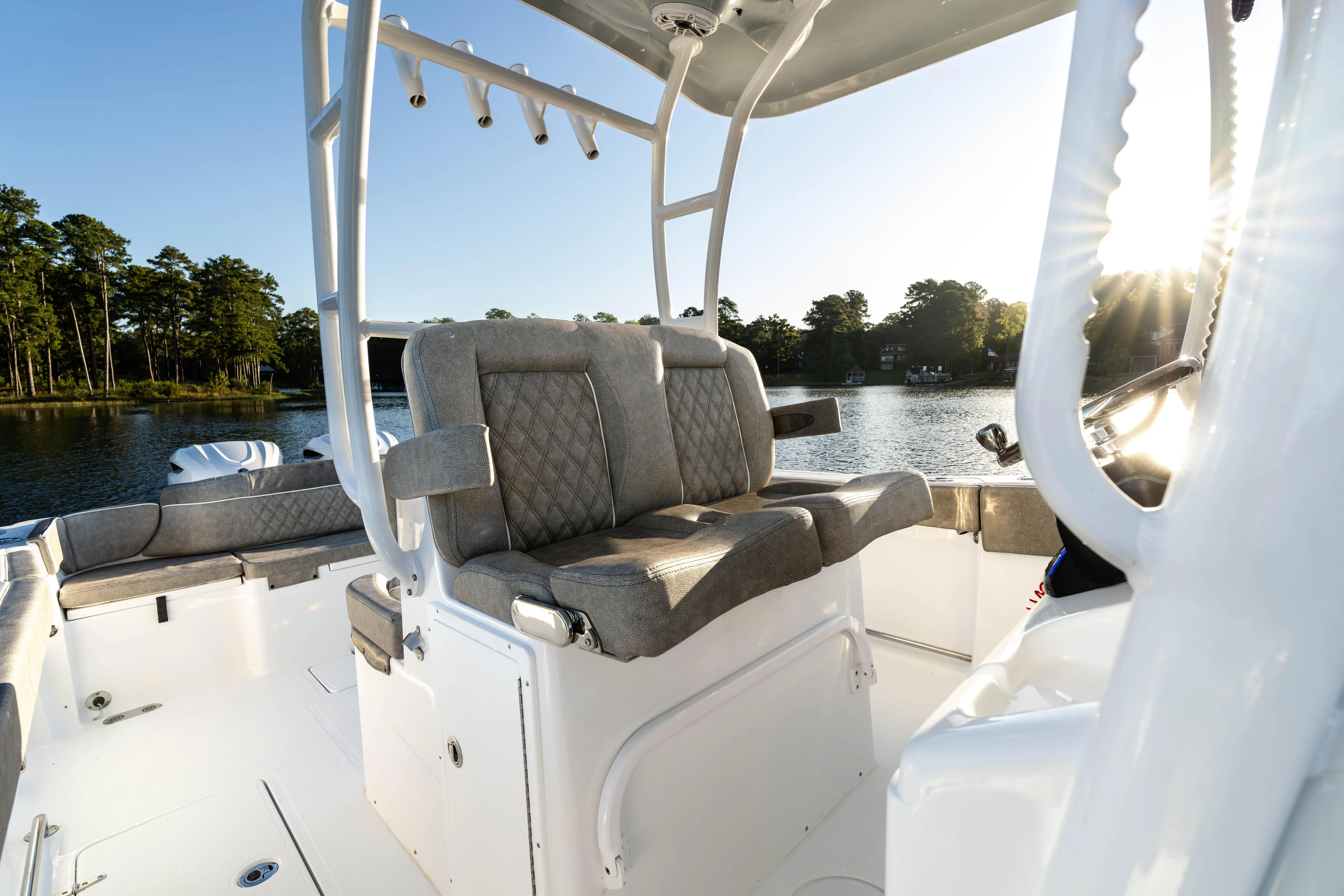  Yacht Photos Pics 2026 Sea Hunt Ultra 305 Coffin Box boat interior with cushioned seating, on a serene lake.