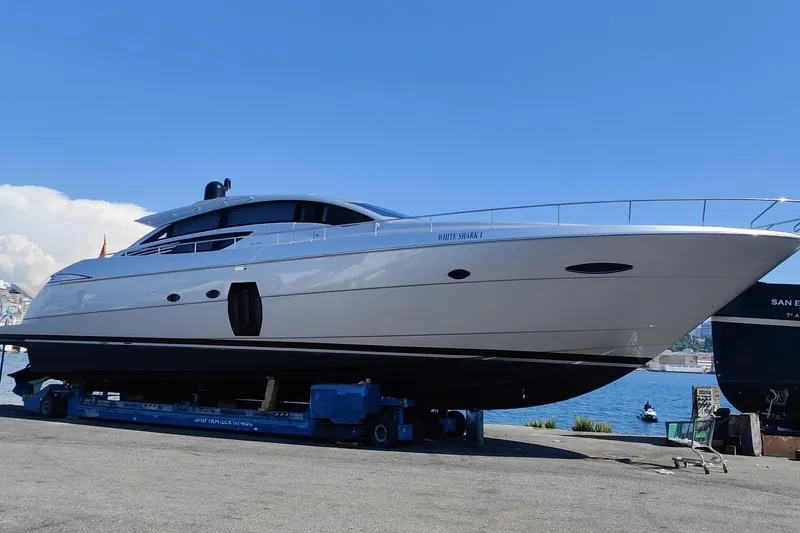 White Shark I Yacht Photos Pics 2010 Pershing 72 yacht on dry dock, sleek design, clear blue sky background.