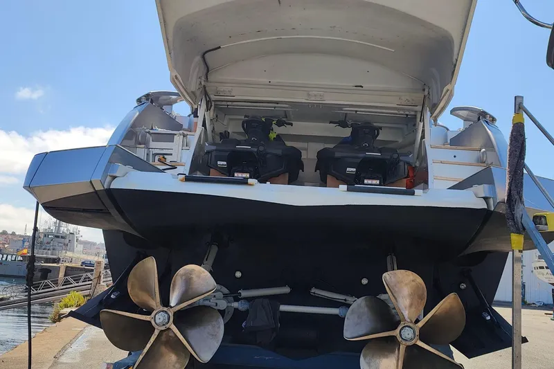 White Shark I Yacht Photos Pics Rear view of a 2010 Pershing 72 yacht with visible propellers and engines.
