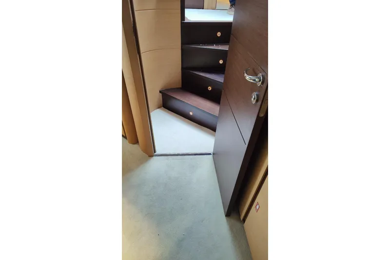 White Shark I Yacht Photos Pics Interior stairs of a 2010 Pershing 72 yacht, featuring wooden steps and modern design.