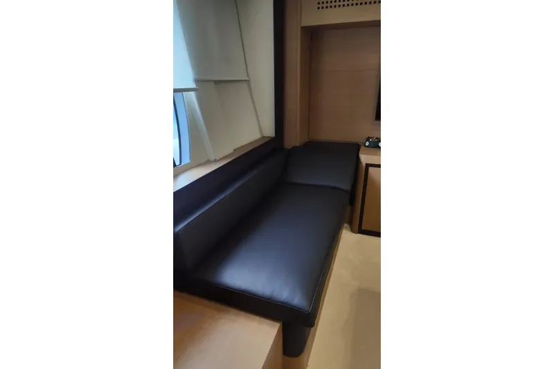 White Shark I Yacht Photos Pics Luxurious interior of 2010 Pershing 72 yacht with sleek black leather seating.