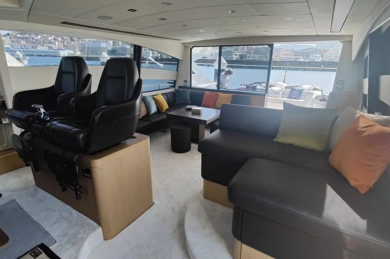 White Shark I Yacht Photos Pics Luxurious interior of 2010 Pershing 72 yacht with plush seating and panoramic windows.