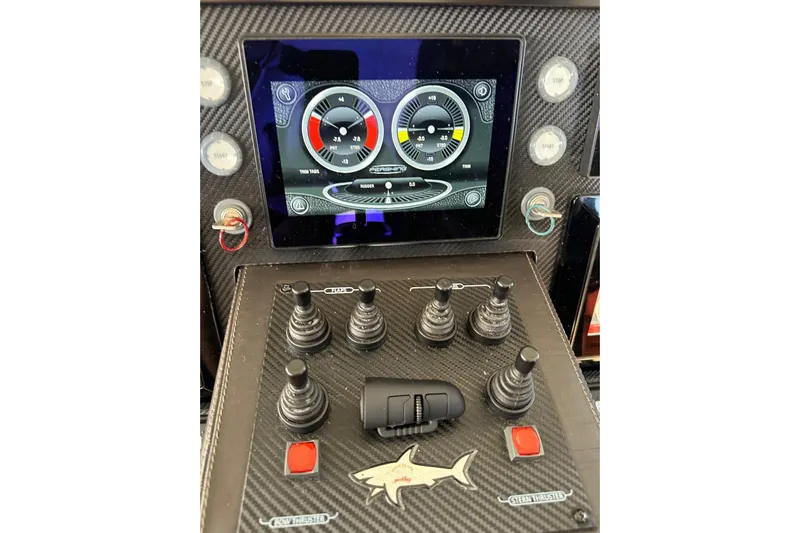 White Shark I Yacht Photos Pics Control panel of a 2010 Pershing 72 yacht with digital display and joystick controls.