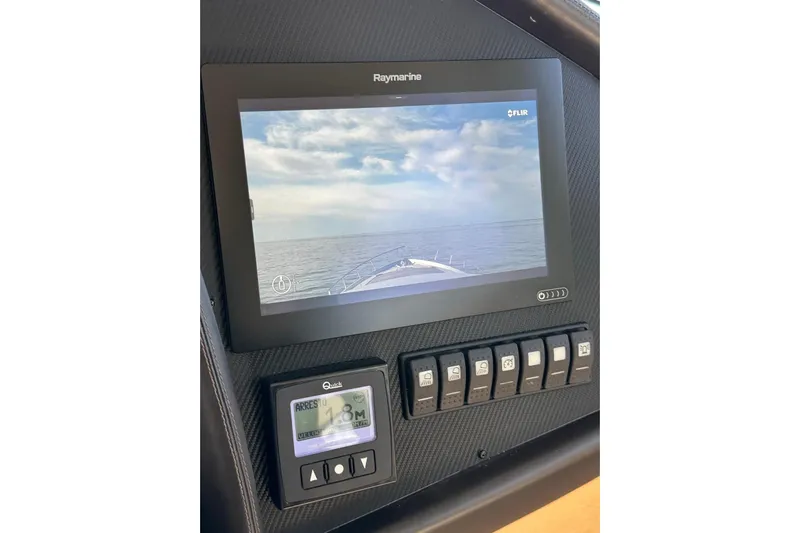 White Shark I Yacht Photos Pics Control panel of 2010 Pershing 72 yacht with Raymarine display and switches.