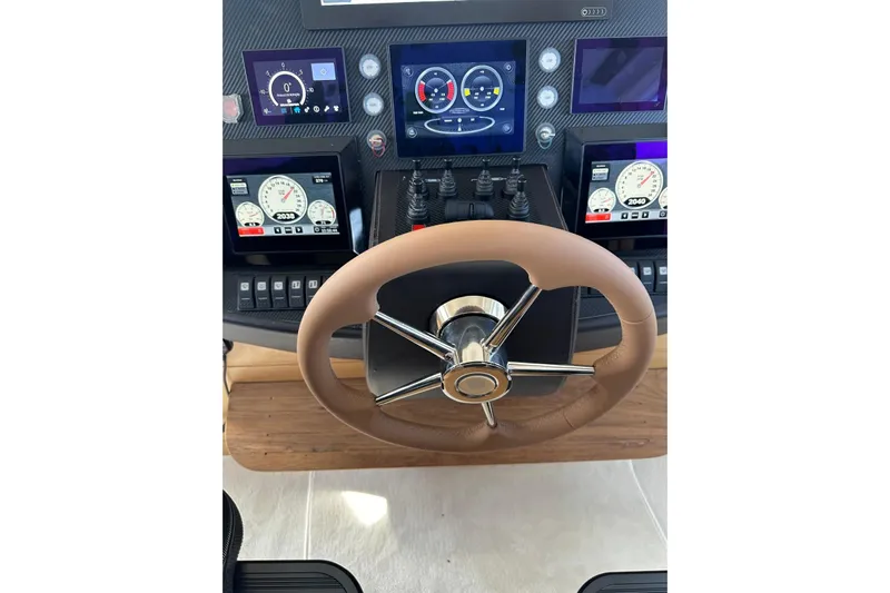 White Shark I Yacht Photos Pics Steering wheel and dashboard of a 2010 Pershing 72 yacht with digital displays.