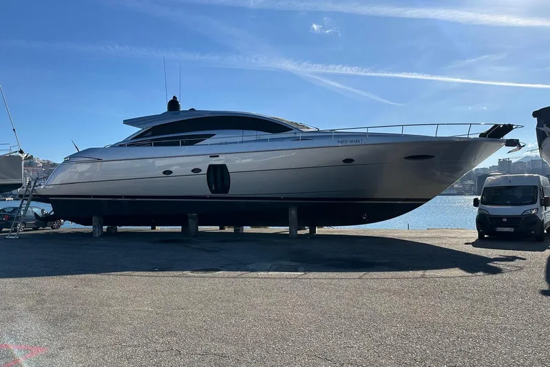 White Shark I Yacht Photos Pics 2010 Pershing 72 yacht on dry dock, with a clear blue sky background.