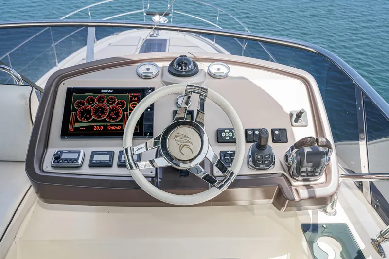 The Riviera Yacht Photos Pics Helm of 2017 Beneteau Monte Carlo 5 MC5 yacht with modern controls and navigation display.