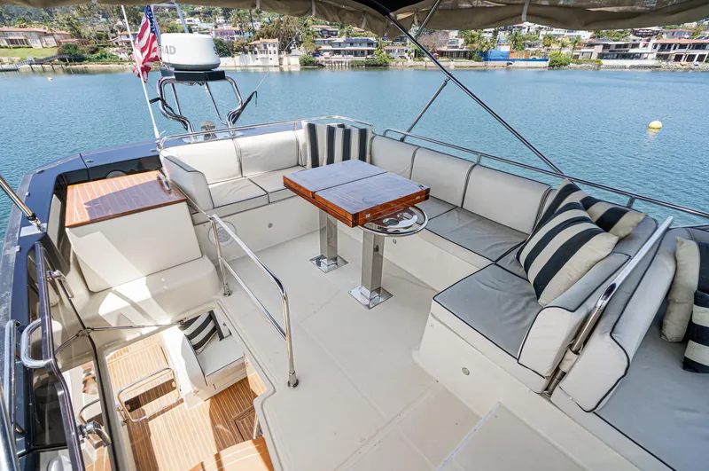 The Riviera Yacht Photos Pics Luxurious 2017 Beneteau Monte Carlo 5 MC5 yacht with spacious outdoor seating and scenic water view.