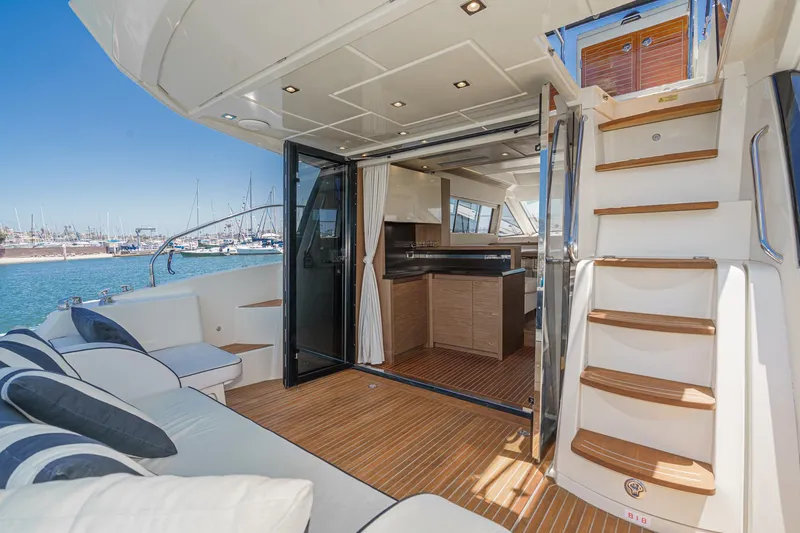 The Riviera Yacht Photos Pics 2017 Beneteau Monte Carlo 5 MC5 yacht interior with open deck and staircase.