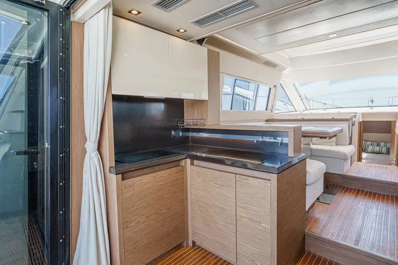 The Riviera Yacht Photos Pics Luxurious interior of 2017 Beneteau Monte Carlo 5 MC5 yacht with modern kitchen and seating area.