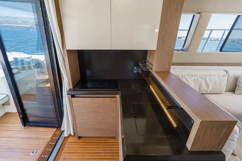 The Riviera Yacht Photos Pics Modern kitchen interior of 2017 Beneteau Monte Carlo 5 MC5 yacht with ocean view.