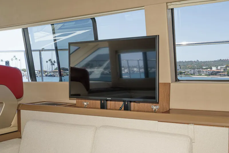 The Riviera Yacht Photos Pics Interior of 2017 Beneteau Monte Carlo 5 MC5 yacht with TV and scenic window view.